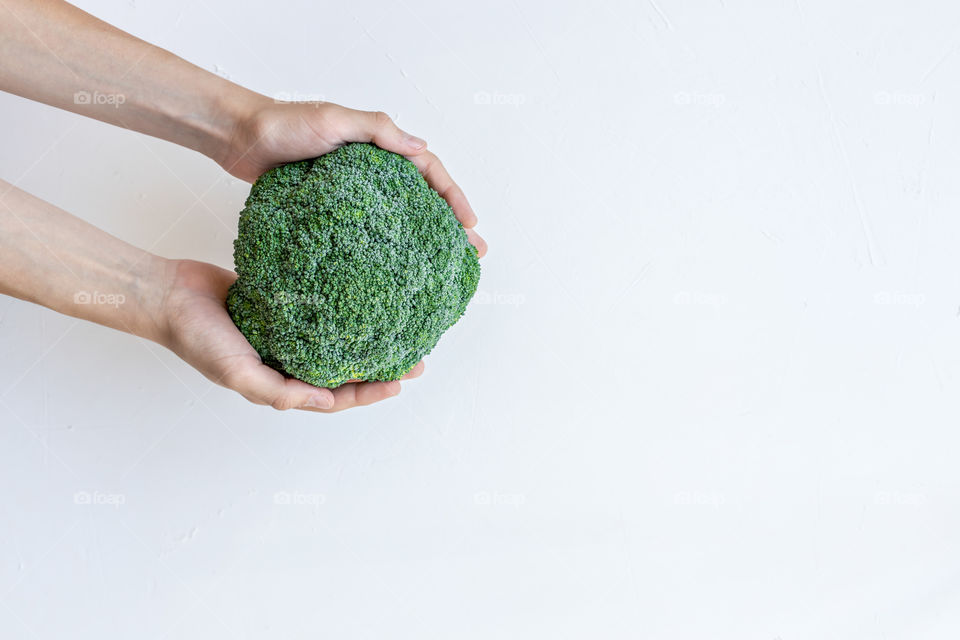 Top view of hands holding a green plant.