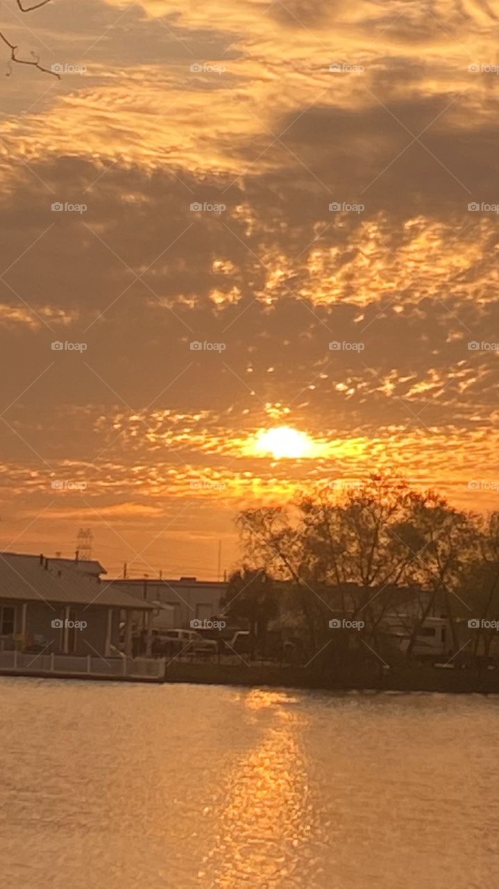 Early evening sunset with 2 separate Reflections on Lake Waters. Evening colors present but lots of clouds also present. So so for good sunset pics.