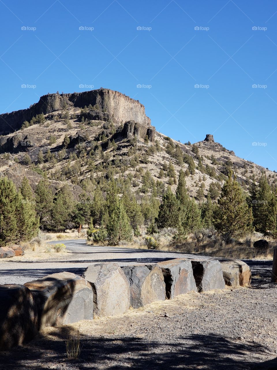 Chimney Rock on the Crooked River Highway in Central Oregon against a beautiful clear blue sky on a fall day. 