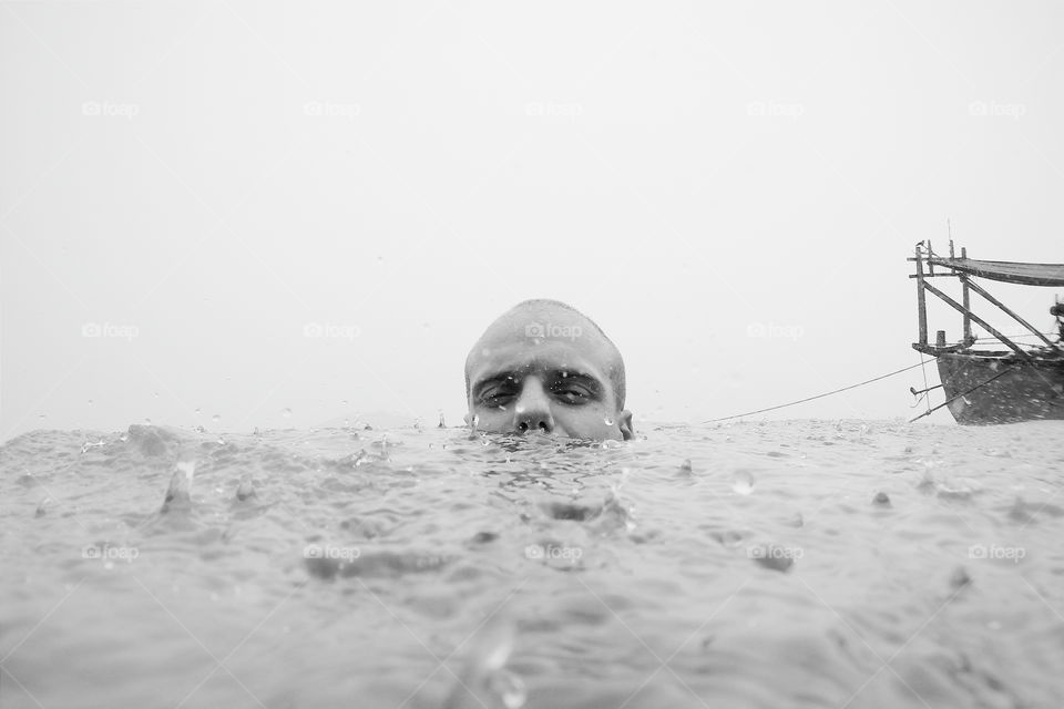 Man's face on surface of an ocean