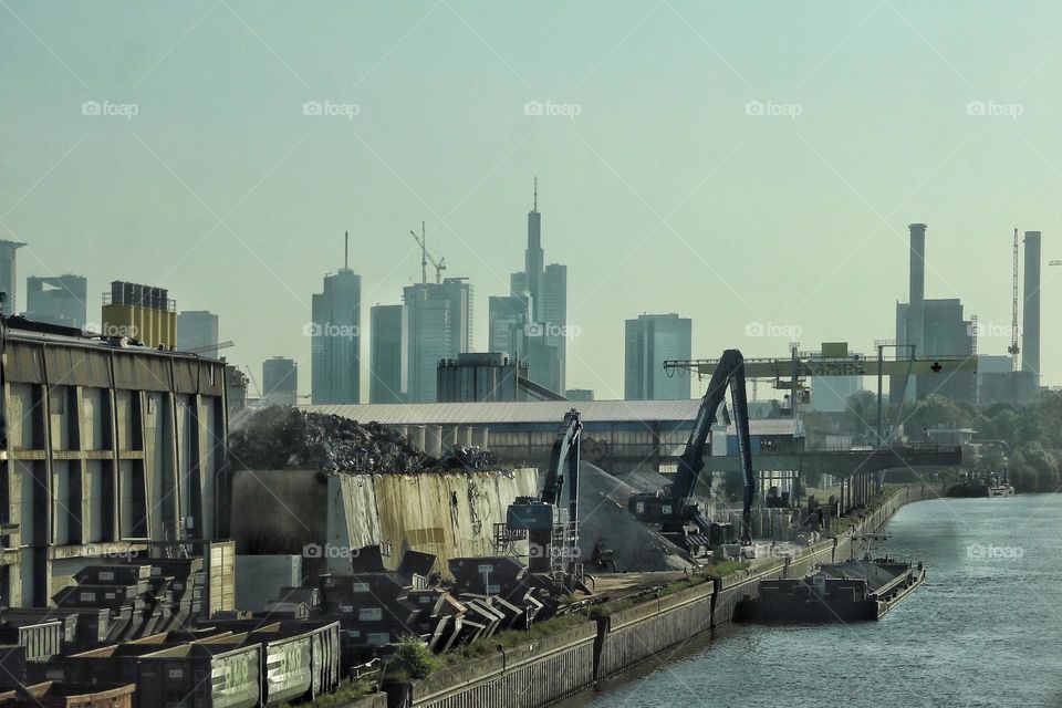 Cityscape of Frankfurt am Main with a view of an industrial port and skyscraper 