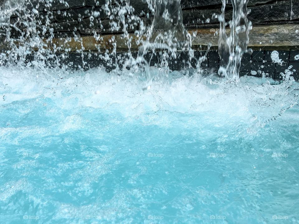 Blue water splashing with bubbles stop motion background 