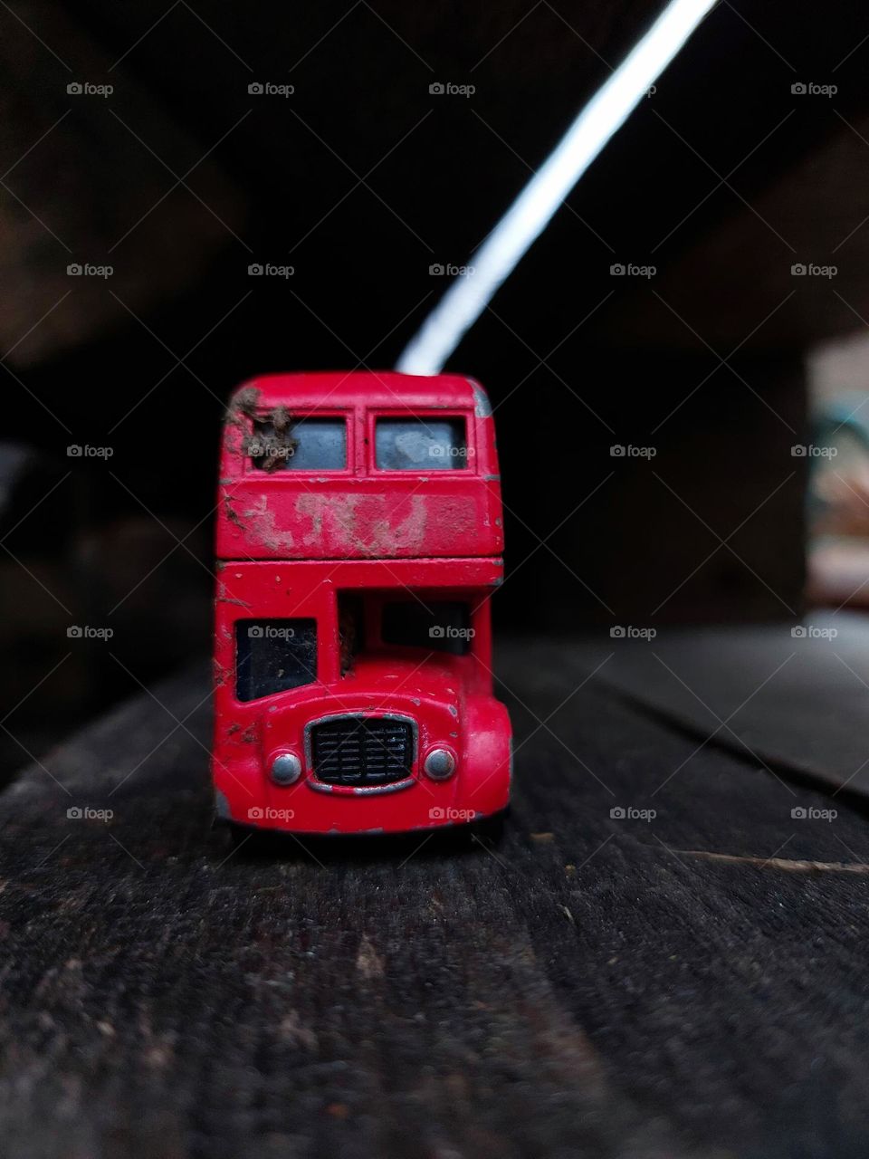 red metal buss toy found outside.