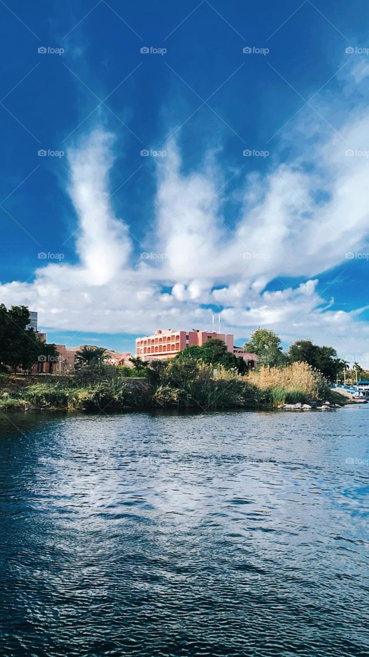 View from a boat in Aswan from the nile with a cloudy sky