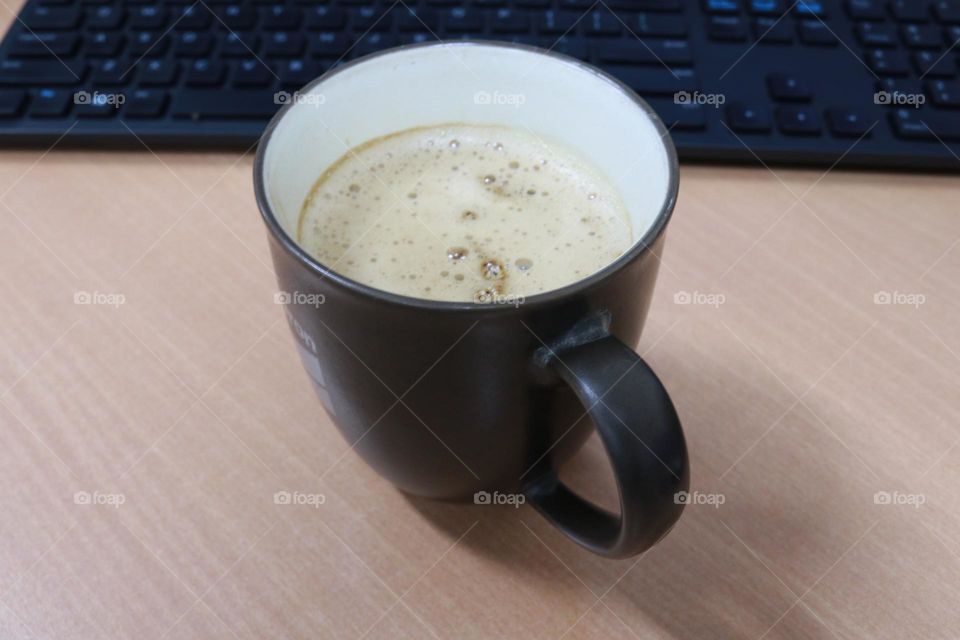 A cup of latte in the morning in an office