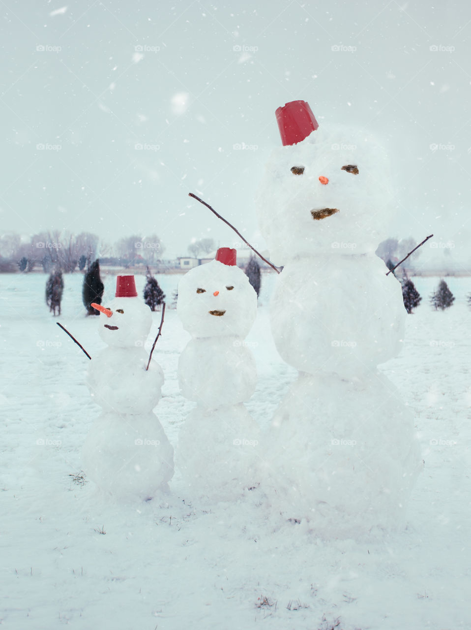 Three snowmen standing in the garden