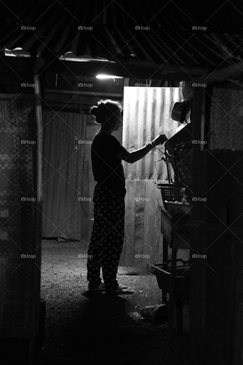 In darkness . Clearing kitchen in Thailand 