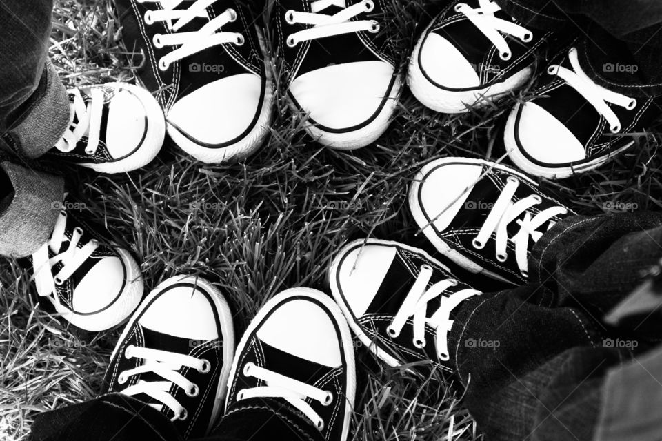 Family in a circle wearing converse tennis shoes 