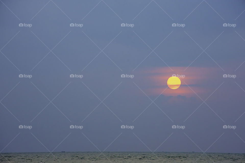 The sun in the morning that reflect the clouds and the sea.