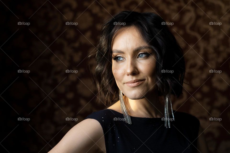 A young beautiful spectacular woman in a black dress. portrait