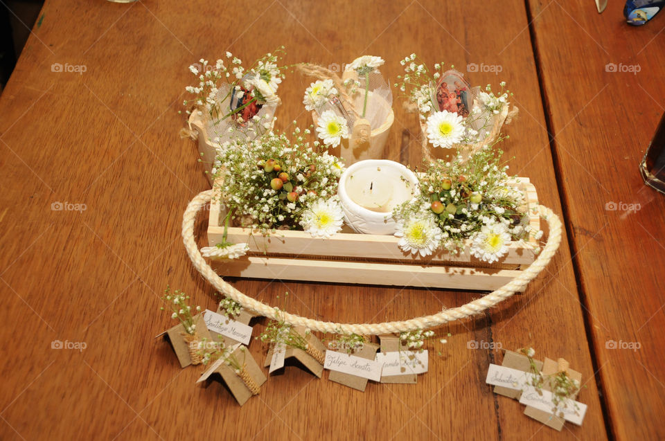 Bouquet of Flowers decorated with candles on wooden table