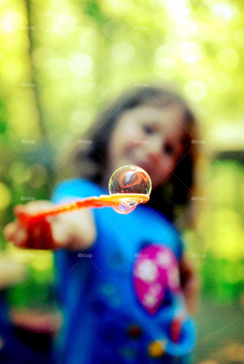 Blowing bubbles. Bubble on a wand