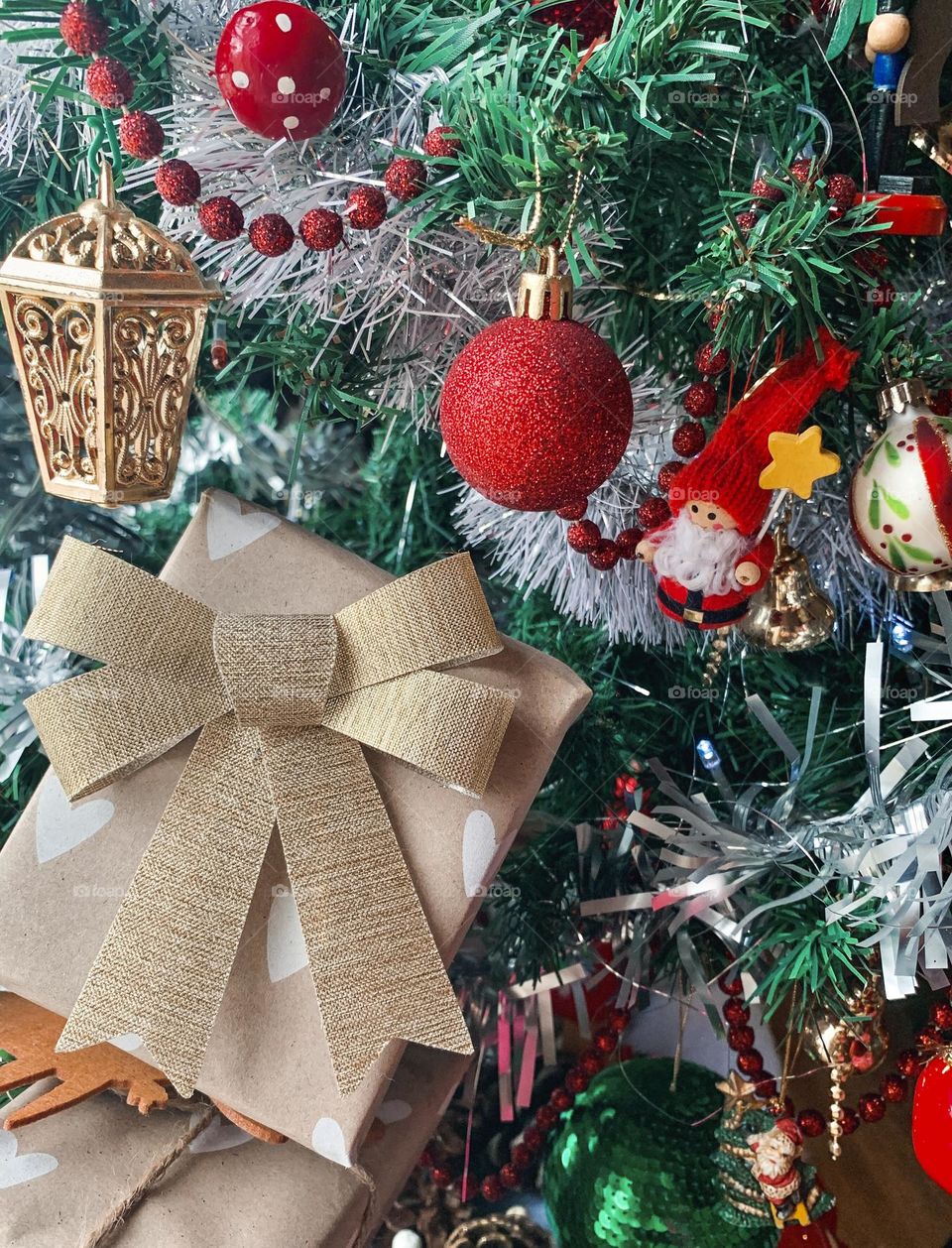 A present amid the decorations on a Christmas tree