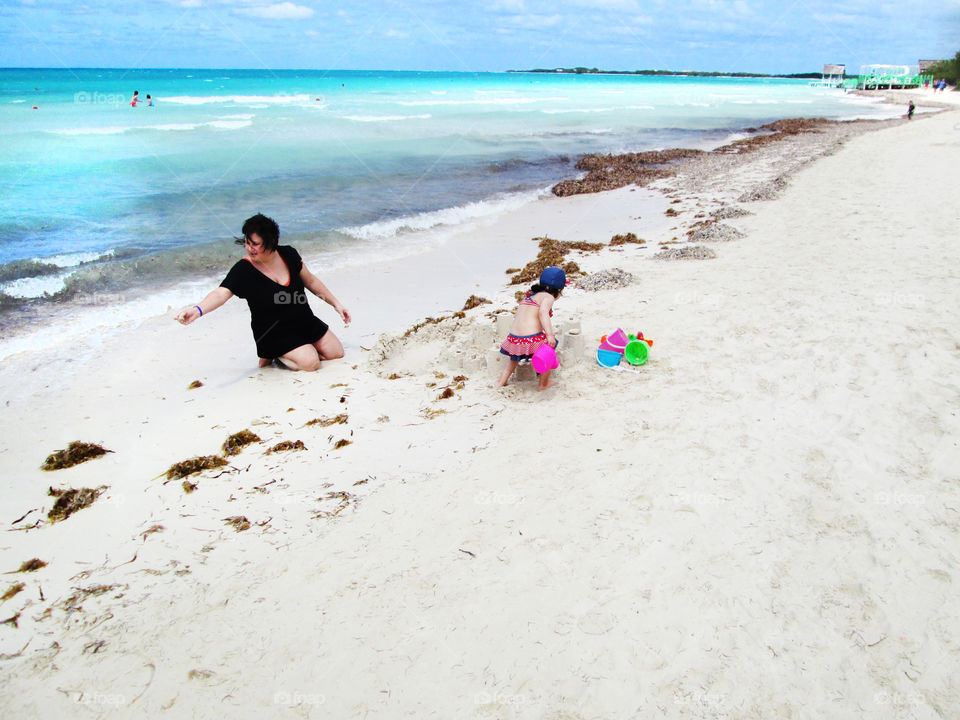 mom and baby. game on the beach