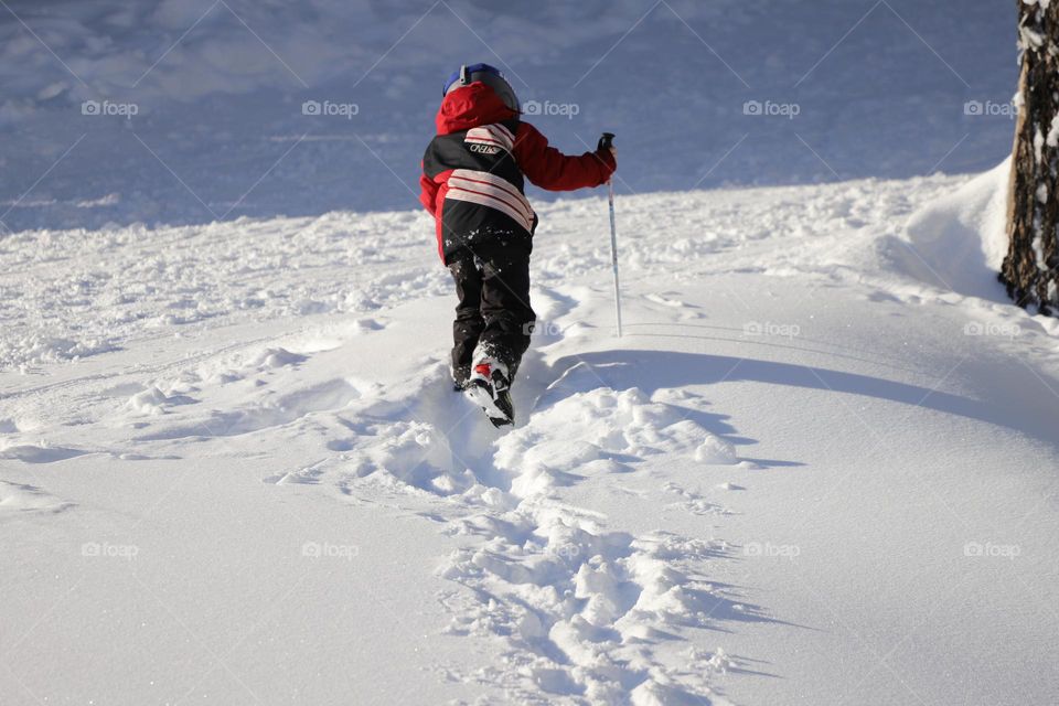 Boy walking in deep snow 