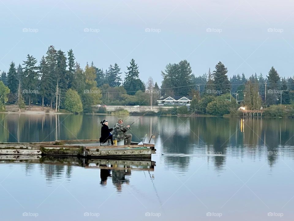 People are fishing on the lake 