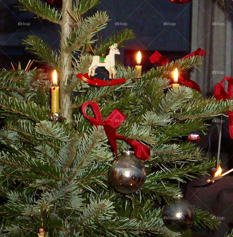 Christmas trees with lit candles 
