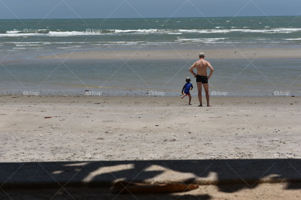 dady and kids in the beach
