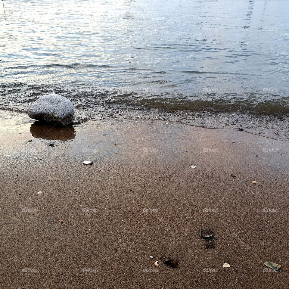 View of a stone in the water.