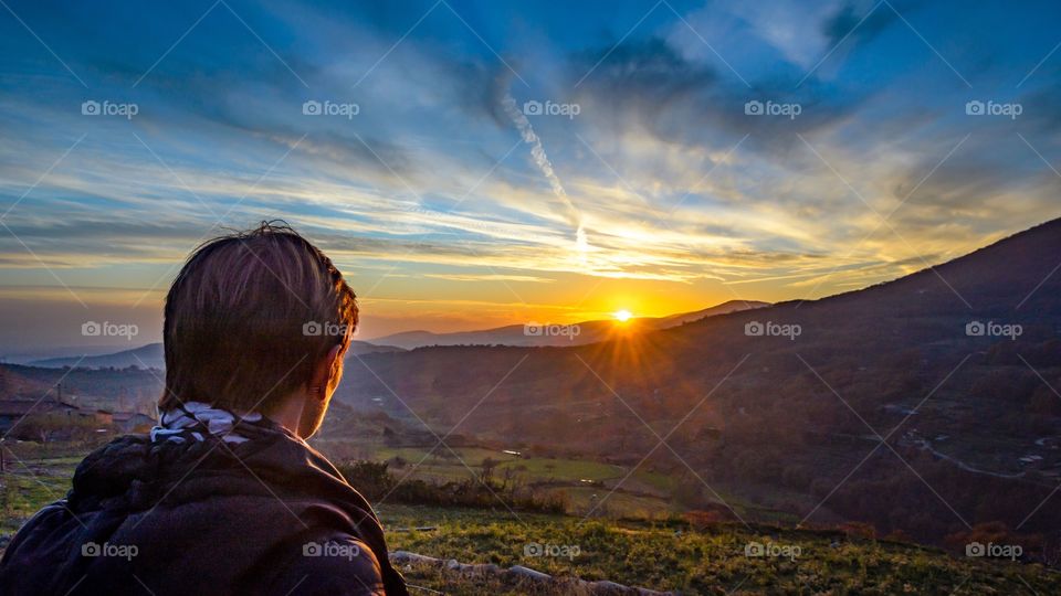 Rear view of a man looking at sunset view