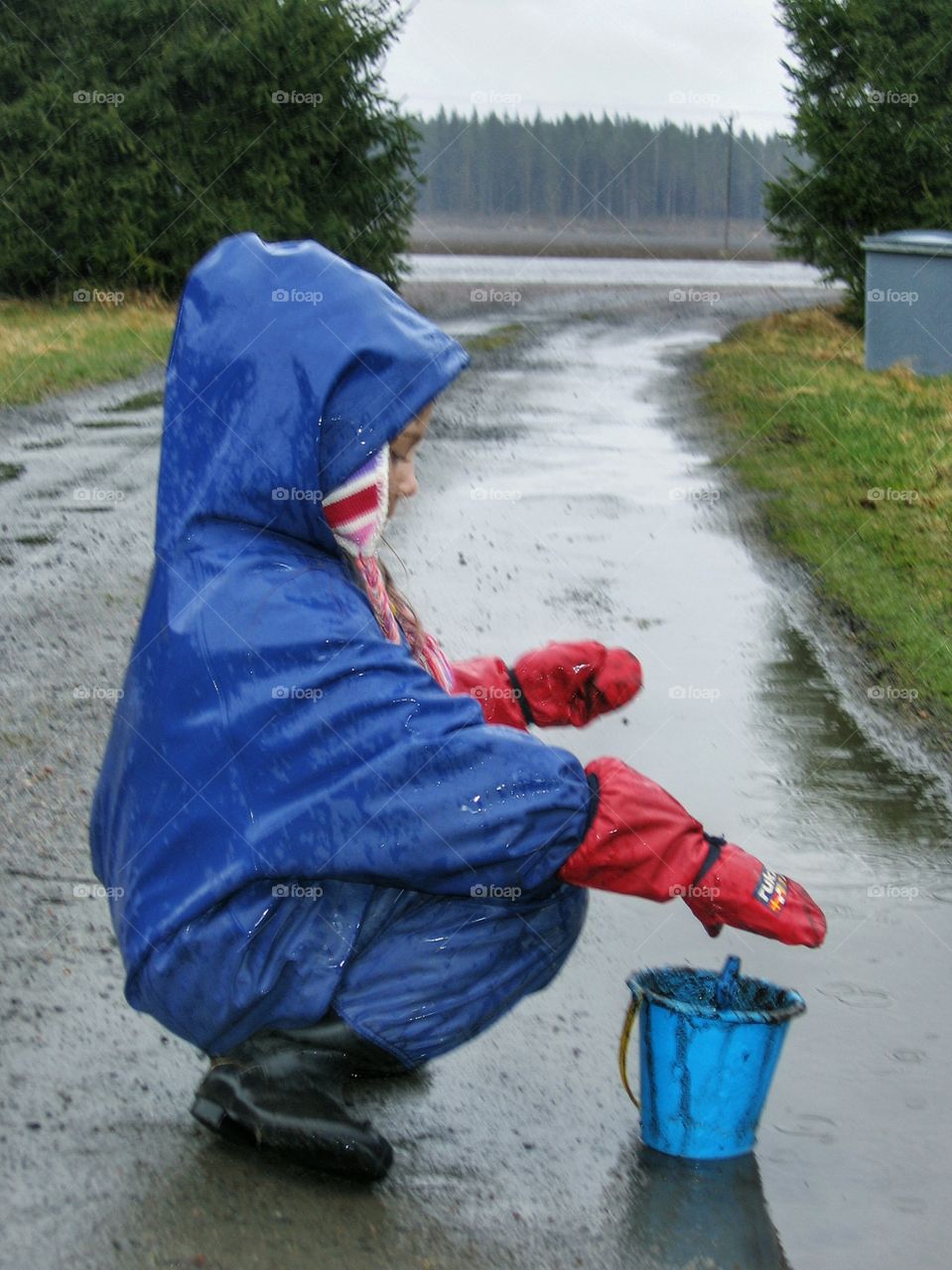 Child playing in rain