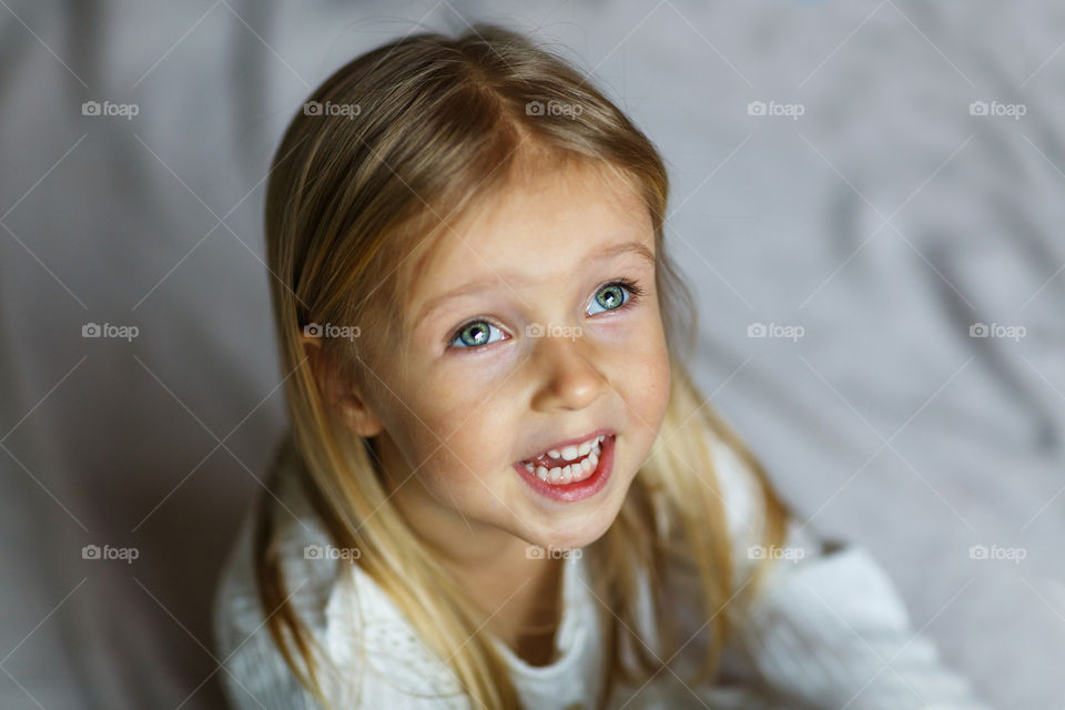 Portrait of cute little girl with blonde hair 