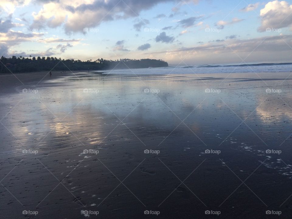 Reflection . Beautiful volcanic sand beach bali 