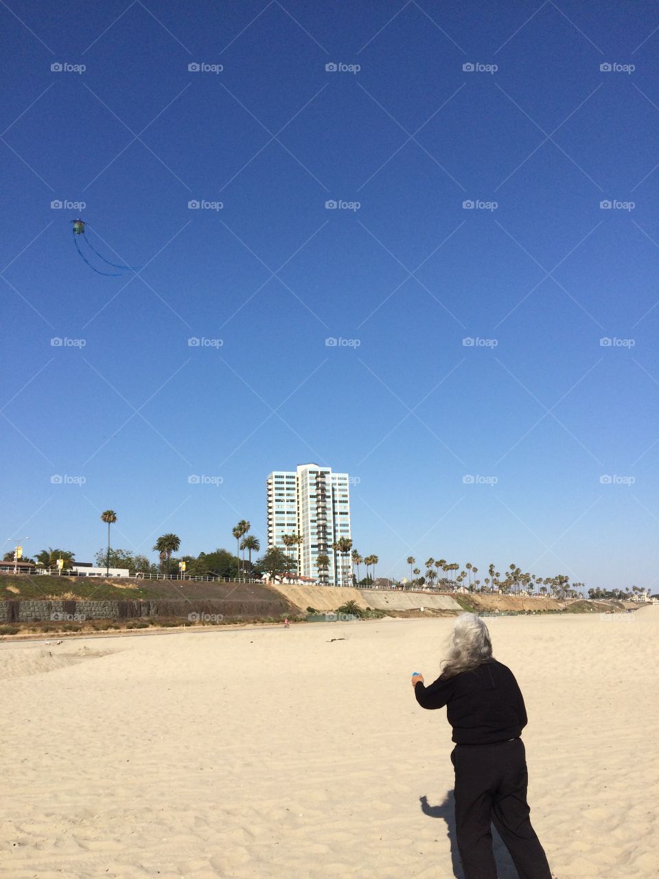 Senior citizen flying kite @ the beach