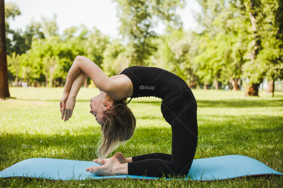 young woman doing yoga in the park