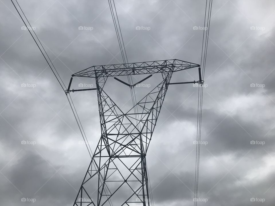 Looking up into the sky with human kinds invention silhouette in front. Amazing wires and electronic equipment is contrasted against nature. Could also go the route of humankind destroying the natural environment. 