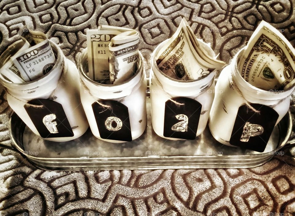 Money in mason jars with Foap written on them for the Foap premium mission