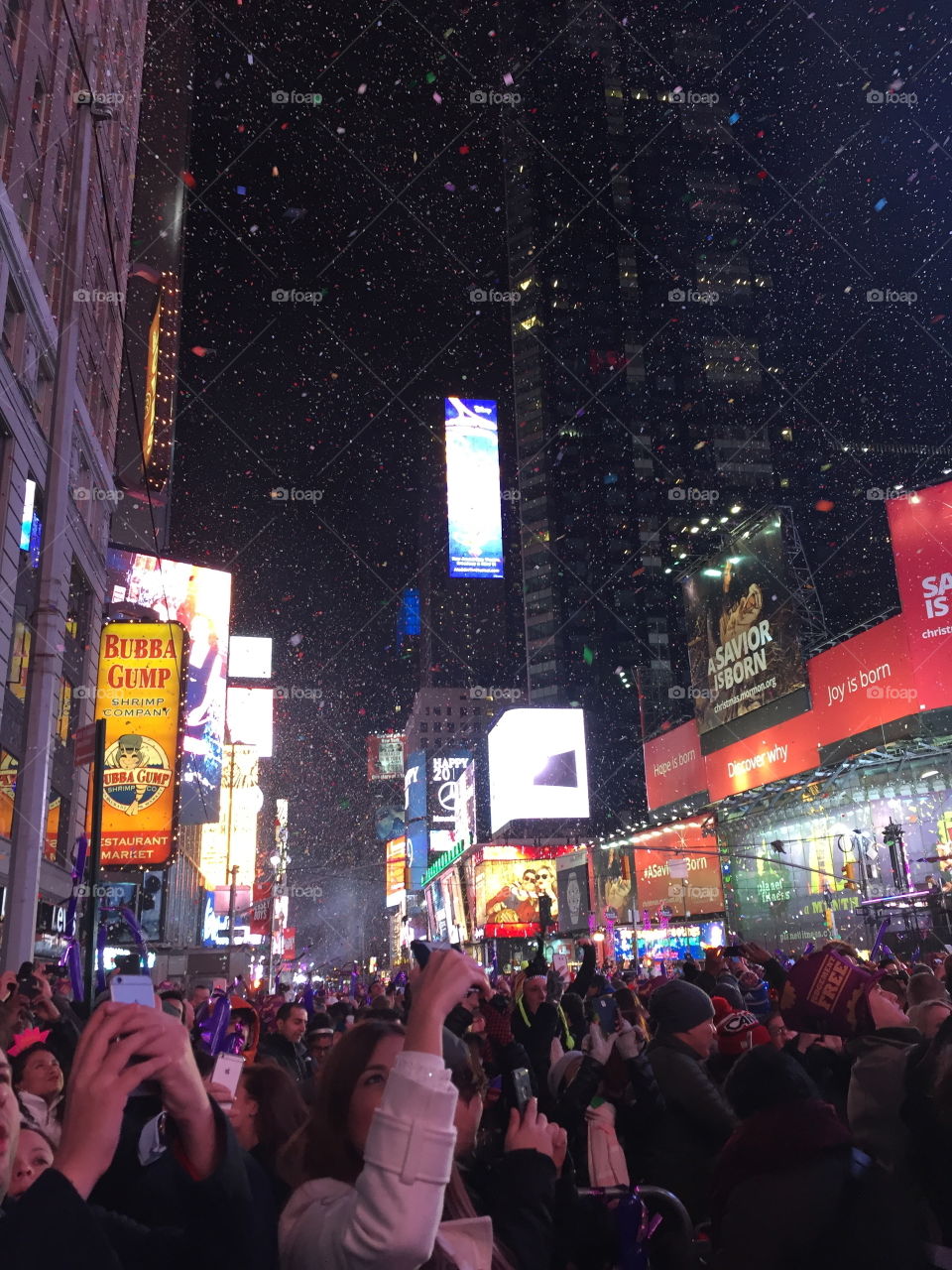 Times Square in NYC New York City on New Year's Eve at midnight as the confetti drops from the sky. 