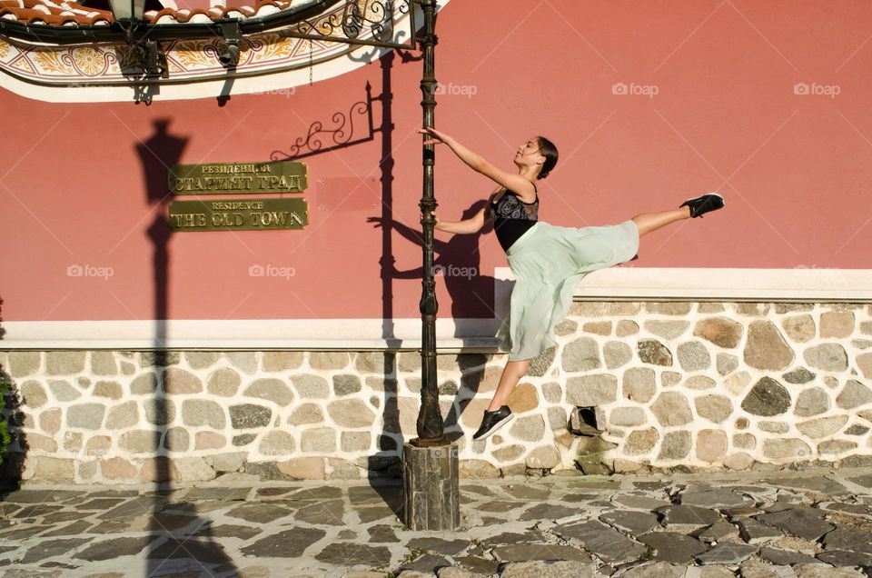 Ballerina jumping on the street