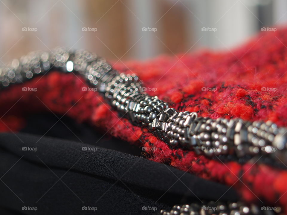 Silvern pearls shining on red texture