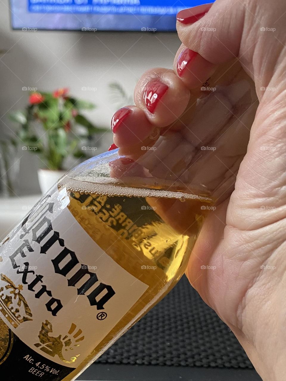 Hand holding bottle with beer