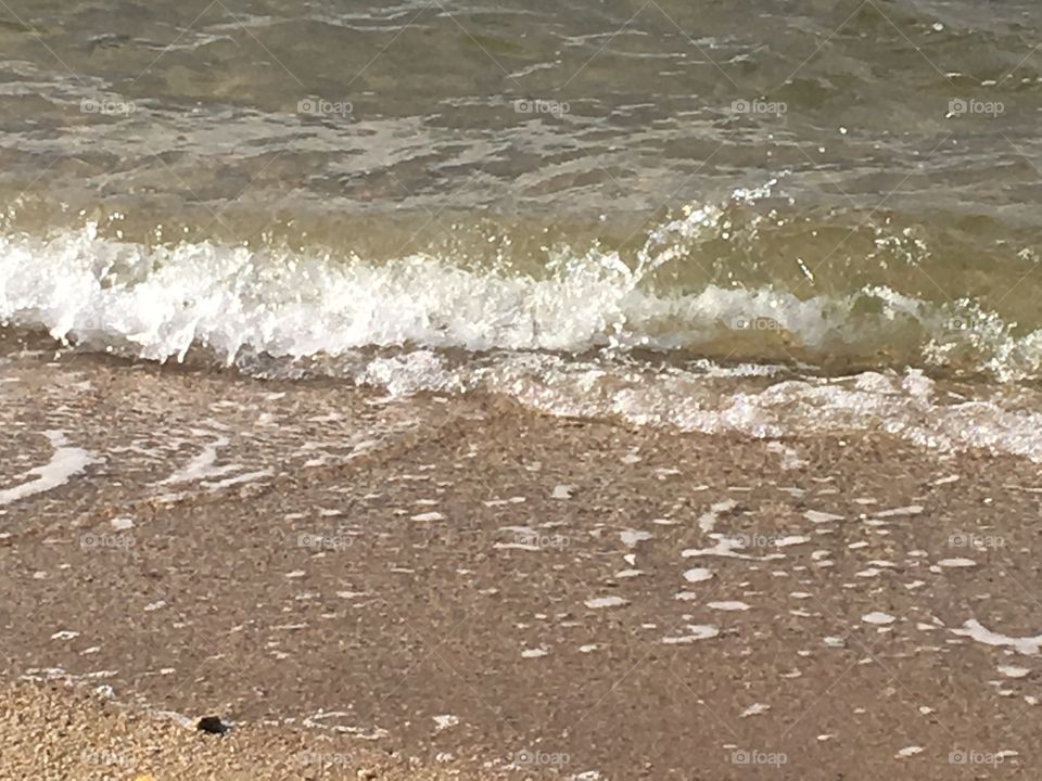 Moving waves crashing on the beach.