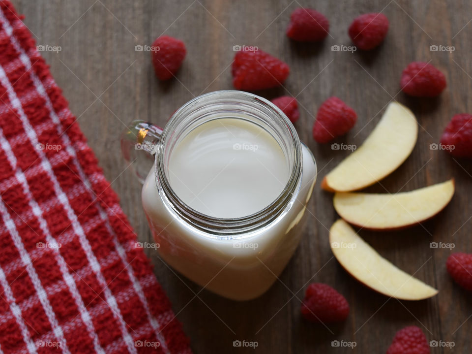 Cold glass of milk with fruit