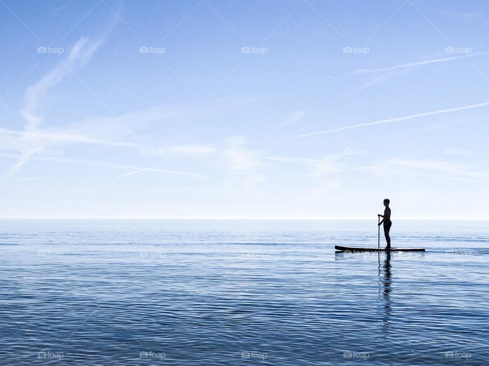 A man paddle boarding in sea 
