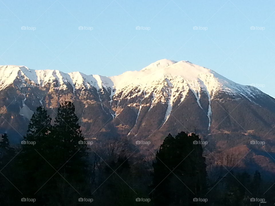 Snow On Mountains Sparkling In Light