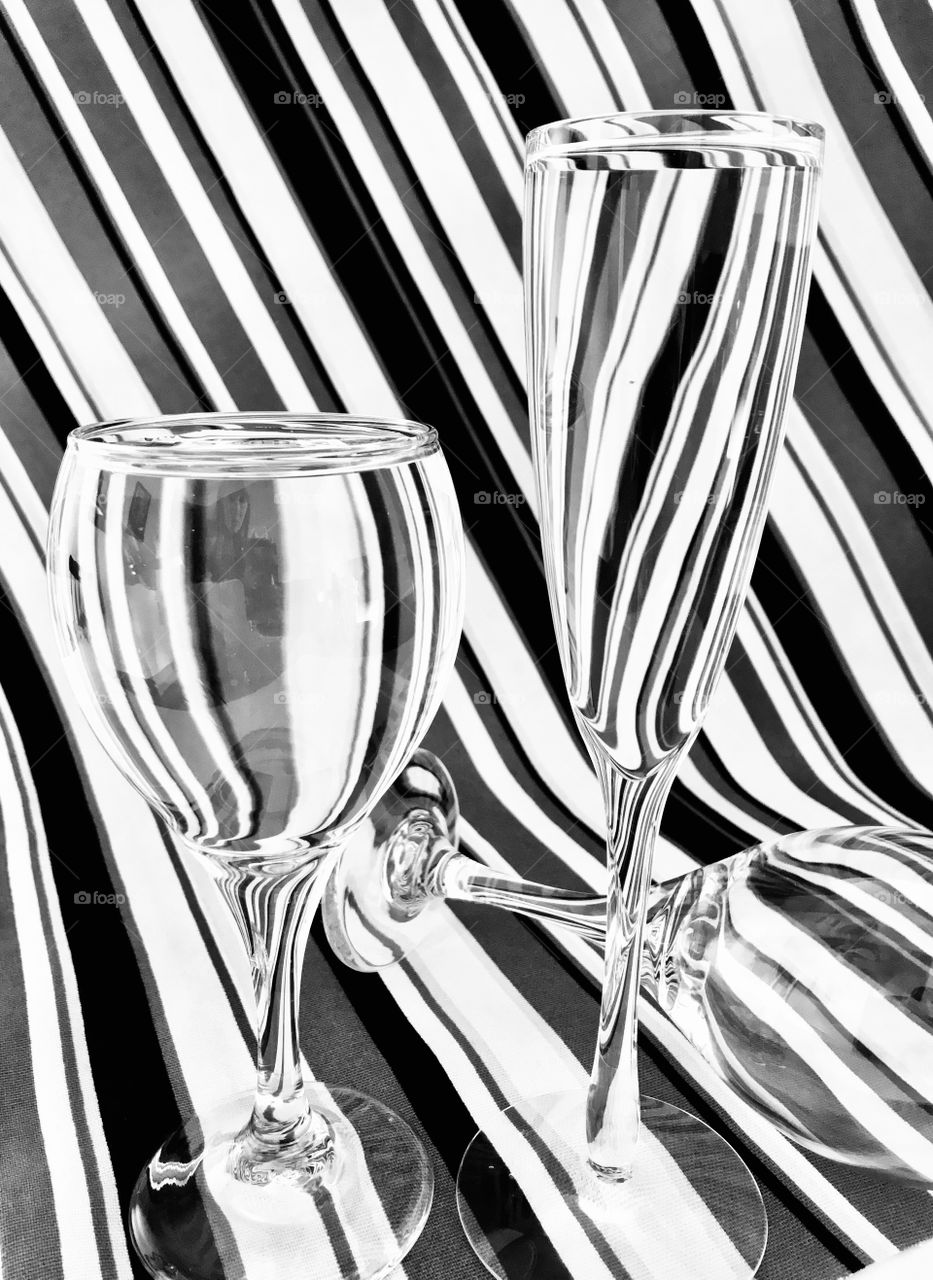 Abstract glasses with water and a striped background 