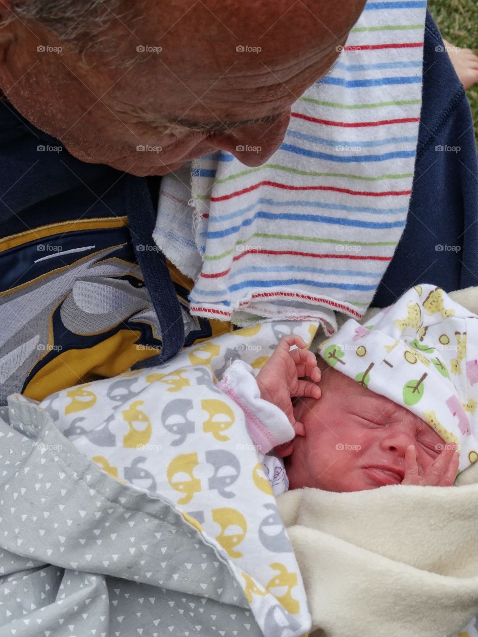 Grandfather Holding Newborn Baby
