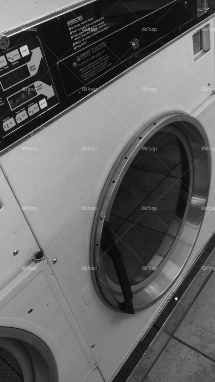 the dryer. black and white picture of the dryer at the laundry mat