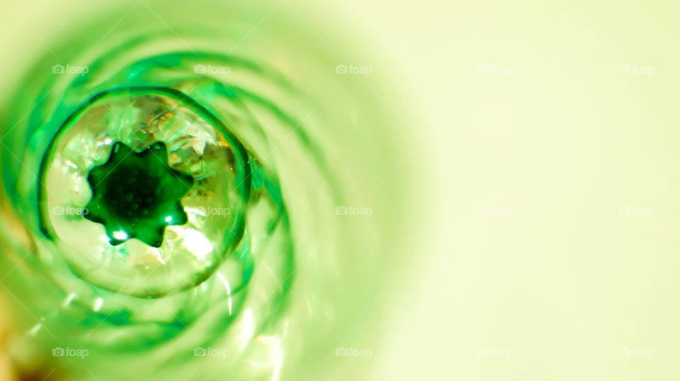 Green spiral closeup detail of green crystal glass with star shape center selective focus with room for copy 