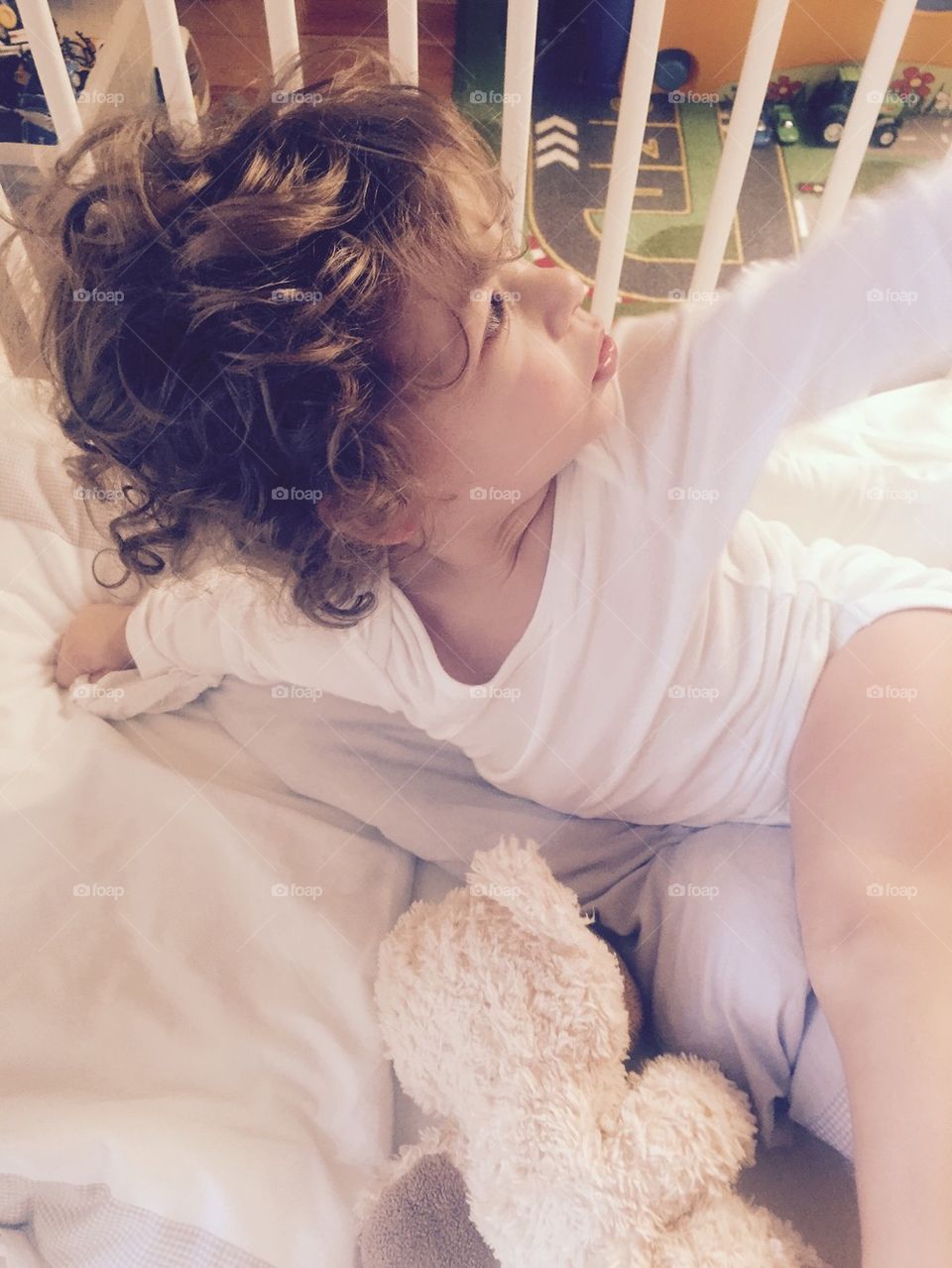 Baby Boy sitting in his Bed 