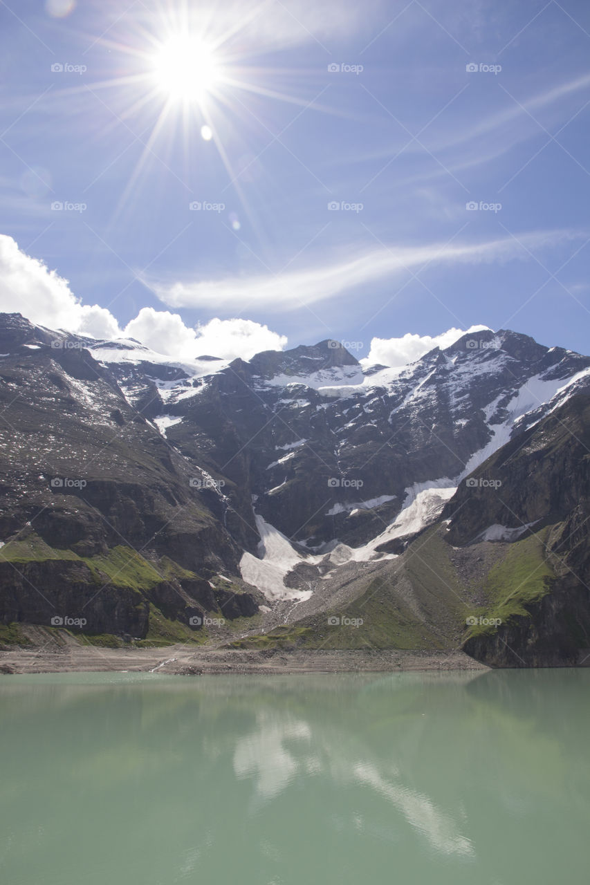 Sunrays over mountain & lake