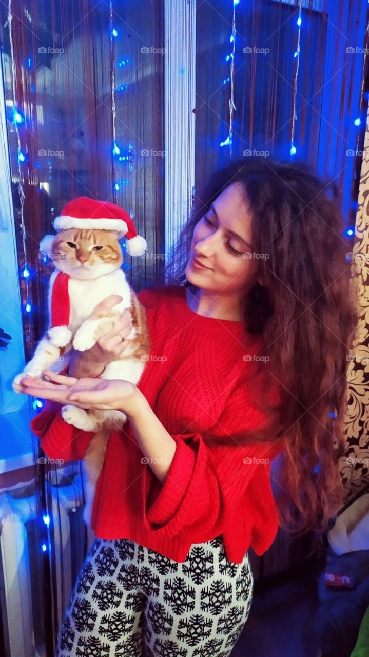 girl holding a cat in a new year costume