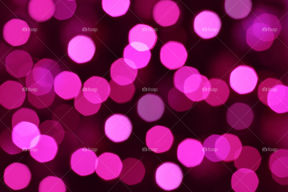 Pink bokeh background. Purple and violet light bokeh on dark.