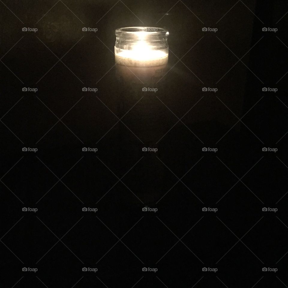 A single candle in the darkness. 