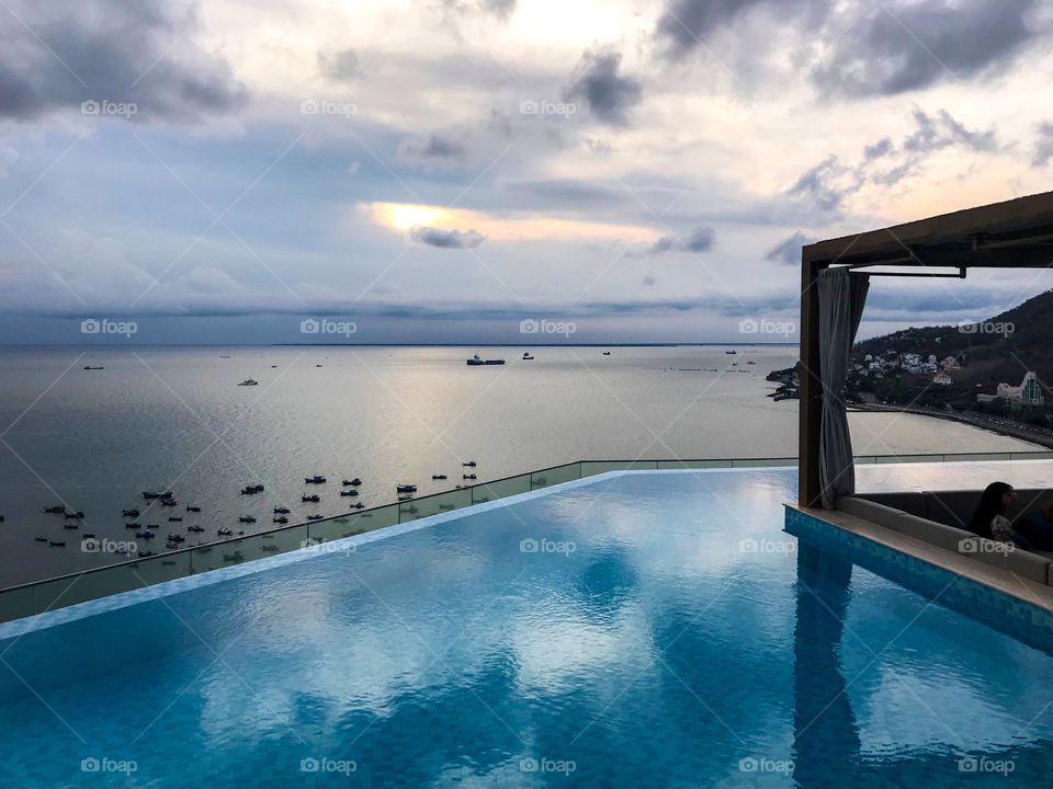 rooftop swimming pool , enjoy sunset and sea breeze , in the distance are fishing boats