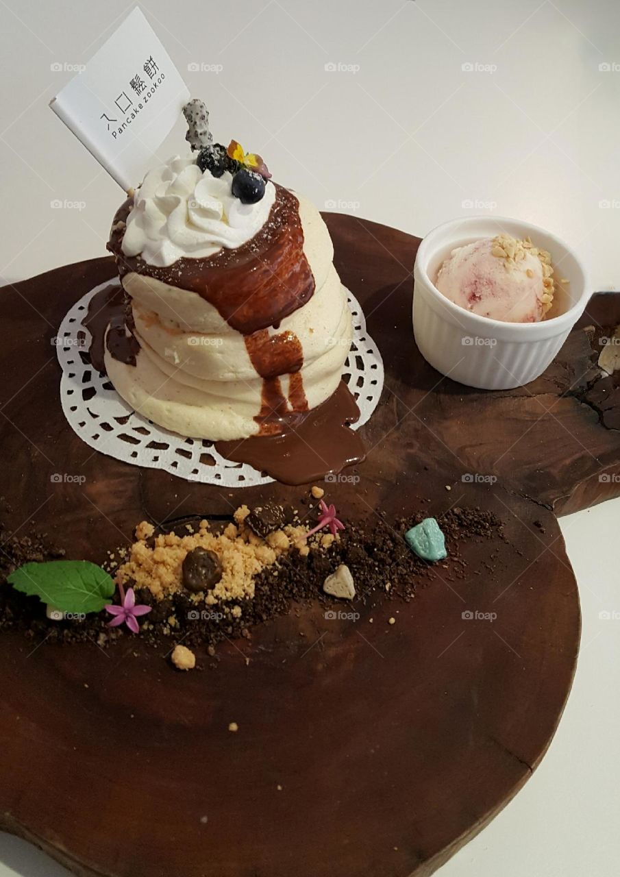 Souffle topped with chocolate sauce and whipped cream, blueberries, served with berry yogurt ice cream